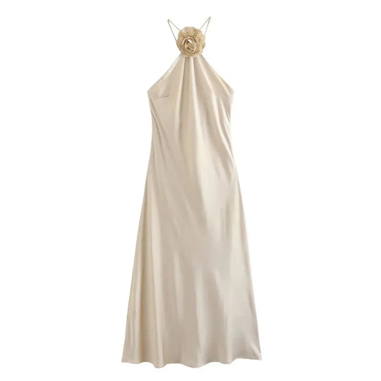 Satin midi dress with a flower on the neckline and thin straps