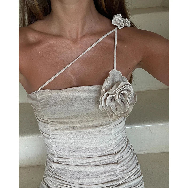 Sensual mini dress with pleats and a decorative flower